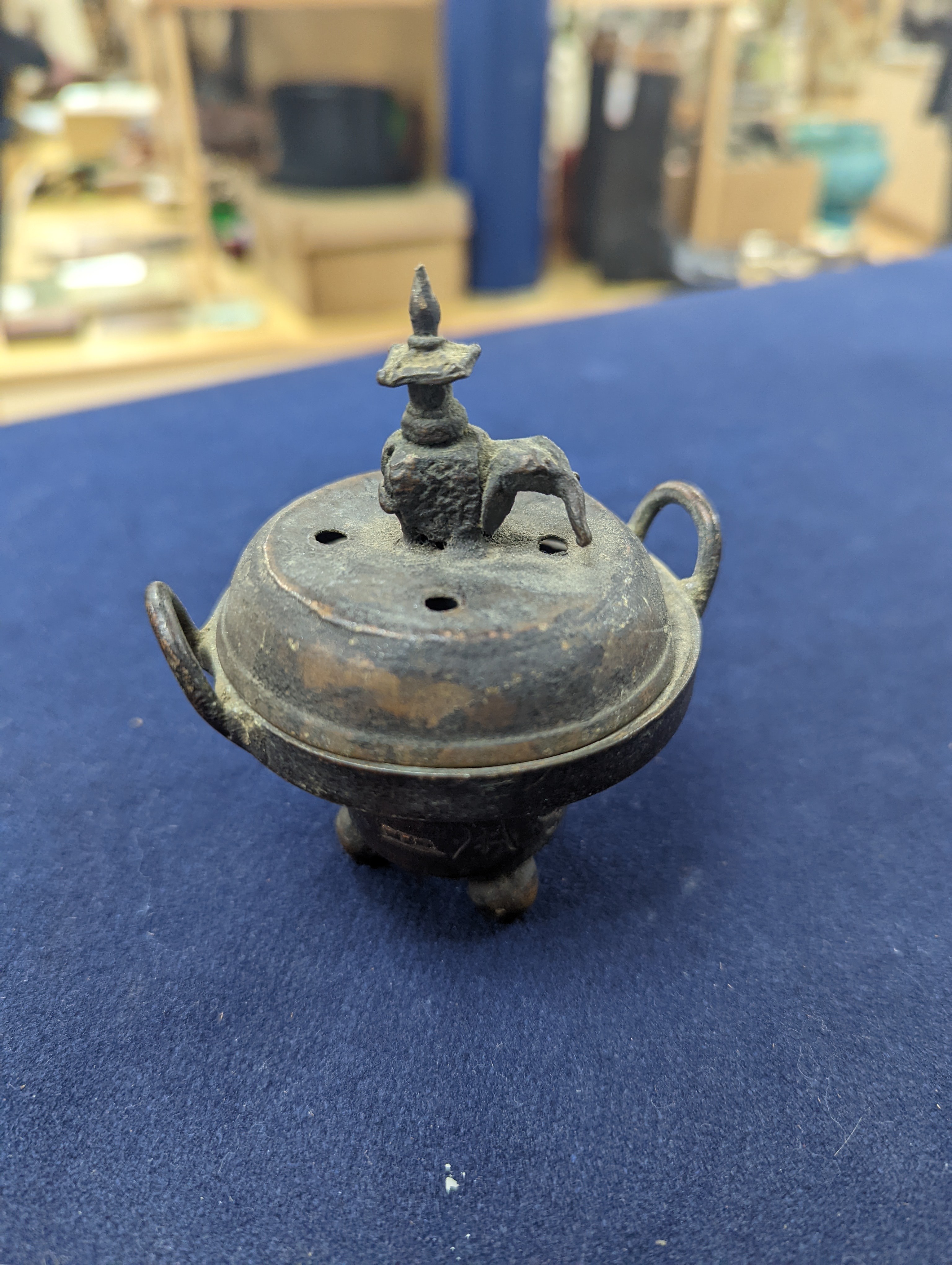 A Chinese gilt copper figure, a Chinese Dog of Fo, a bell, a censer, six Indian bronze figures and a scroll box